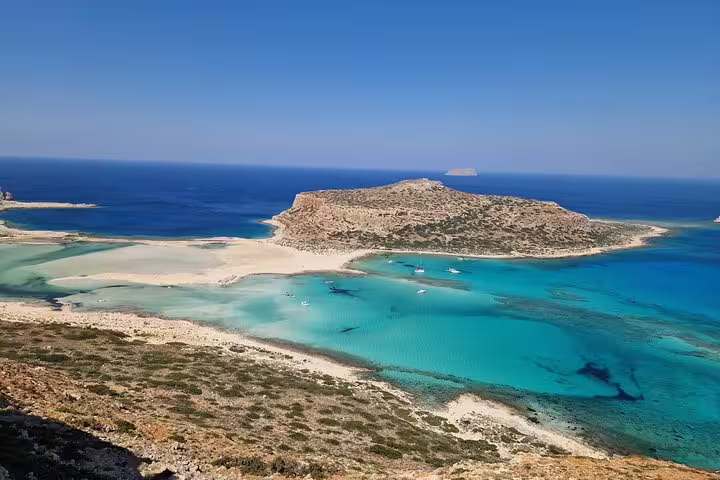 Expansive view of Balos Lagoon's crystal-clear waters and sandy beaches, ideal for a seafood lunch and wine tour.