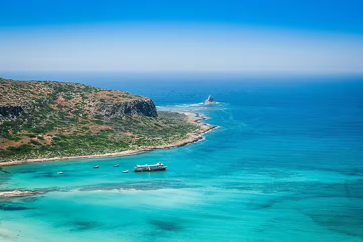 Aerial view of Balos Lagoon's turquoise waters and rugged coastline, ideal for a private tour and wine tasting adventure.