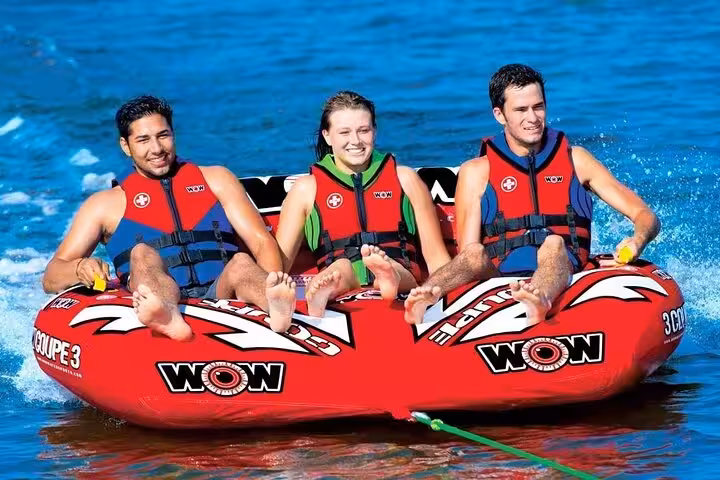 Group riding a towable banana boat on the Red Sea in Sharm El Sheikh, fun water sports and sea activities