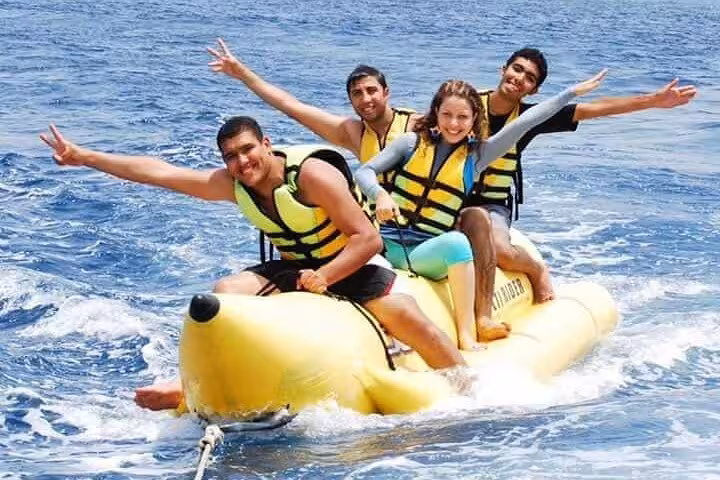 Banana boat ride in Sharm El Sheikh, Red Sea water sports fun with life jackets on adventure tour