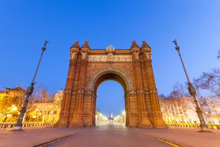 Stunning view of Barcelona's Arc de Triomf at dusk, a highlight on the Barcelona and Montserrat tour with hotel pickup.