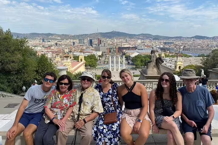 Tourists enjoying panoramic views of Barcelona from a scenic viewpoint on a city tour.
