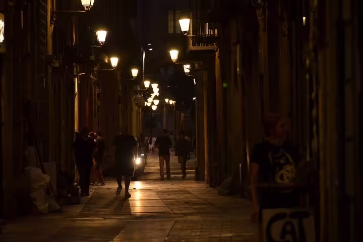 Mysterious dimly-lit alleyway in Barcelona, perfect for exploring ghostly tales on the Dark Past Walking Tour.