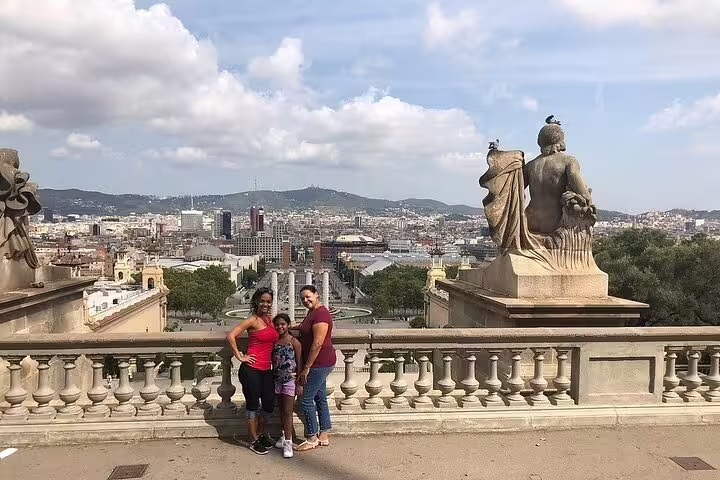 Family enjoying a panoramic view of Barcelona from a historic terrace, capturing the city's stunning skyline and landmarks.