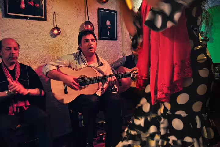 Flamenco guitarist and dancer perform passionately in an intimate Barcelona setting, highlighting the Tapas, Wine, and Flamenco Private Tour experience.