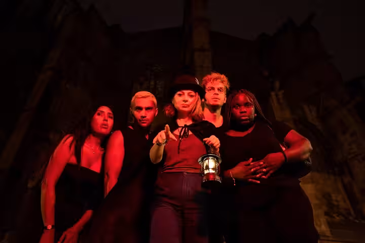 Group explores haunted alleys on Barcelona Ghosts and Legends Gothic Quarter Tour with lanterns.