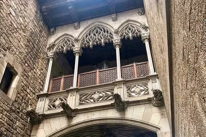 Gothic architecture on a historic balcony in Barcelona's El Born district, featured in a walking tour with flamenco show and tapas.