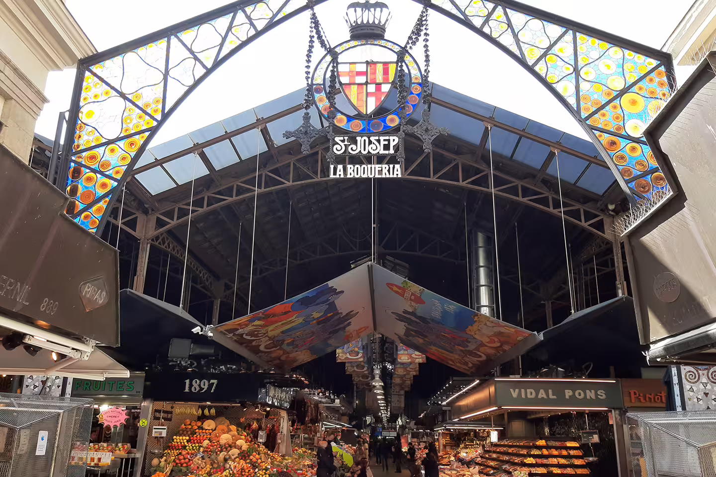 Explore vibrant La Boqueria Market in Barcelona's Gothic Quarter on a guided walking tour with diverse food stalls.
