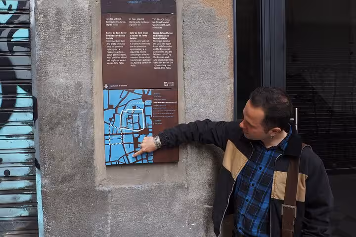 Local guide pointing at map on Barcelona Gothic Quarter street, intro walking tour to El Born old town