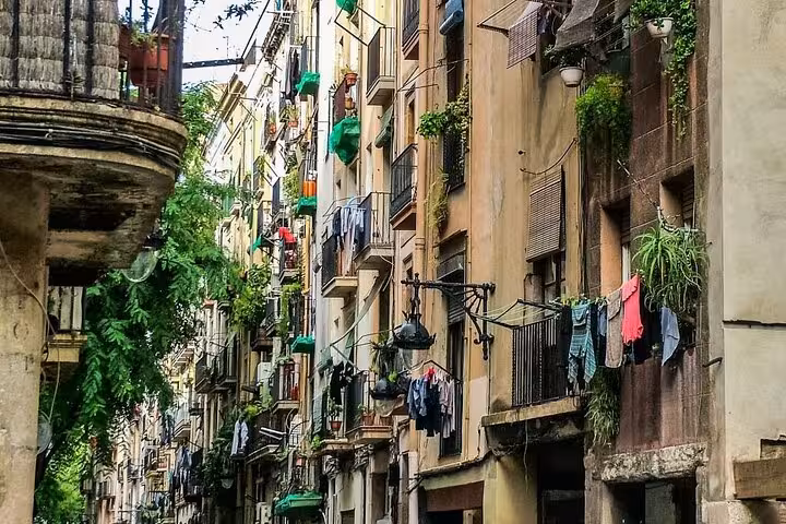 Narrow Barcelona Old Town street with balconies and hanging laundry, typical Gothic Quarter and El Born vibe