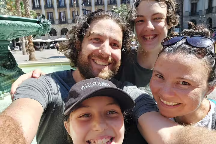 Family selfie by Plaça Reial fountain, Barcelona, on a Gothic Quarter scavenger hunt and highlights walk