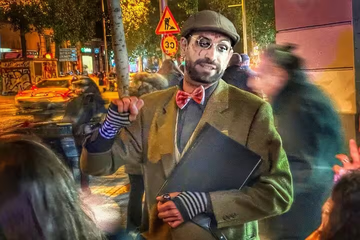 Guide dressed in vintage attire engaging with participants on the Barcelona Ghosts of a Dark Past Walking Tour.