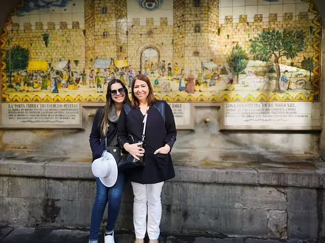 Visitors enjoy Barcelona's historic charm in front of a vibrant mural on the Highlights & Secrets Private Tour with tapas.