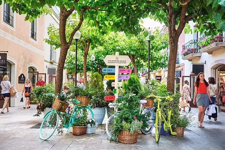 Bicycles and vibrant signs in La Roca Village, offering a scenic stop on the Barcelona City tour.