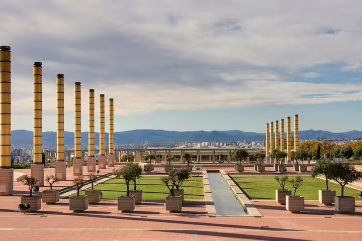 Scenic view of Montjuïc Olympic Park in Barcelona with striking columns and greenery, part of the Barcelona Highlights tour.