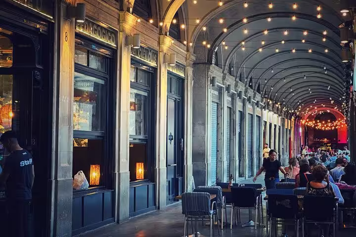 Charming old town arcade with string lights and outdoor dining, perfect for the 1.5h Private Old Town Tour experience.