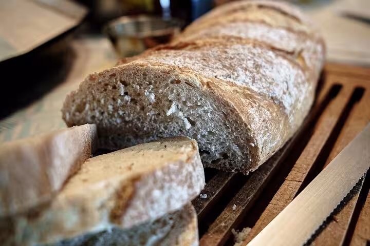 Freshly sliced artisan bread on a cutting board, part of the Barcelona paella and sangria cooking class.