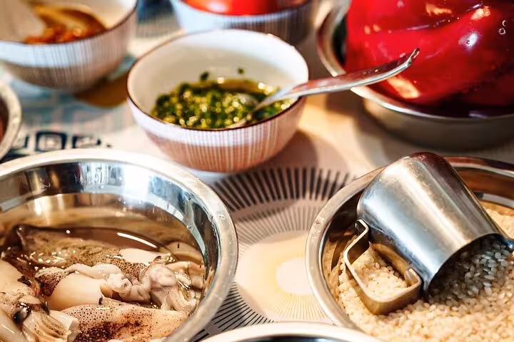 Fresh ingredients for paella including squid, rice, and peppers, ready for a cooking class in Barcelona.