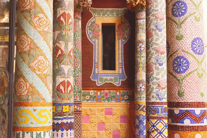 Colorful mosaic columns at Barcelona's Palau de la Música Catalana, showcasing intricate designs on a private tour.