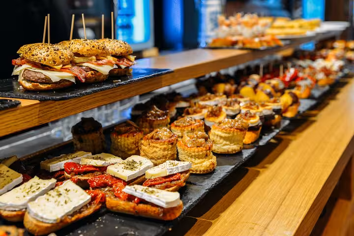 Colorful pintxos and tapas display in a Barcelona bar, authentic local tapas tour with wine tasting