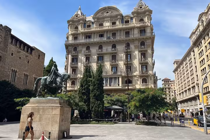 Historic plaza in Barcelona with a grand building, setting the scene for a cultural cooking class tour.