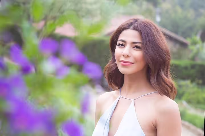 Portrait session in Barcelona garden with purple flowers on a private tour with personal travel photographer