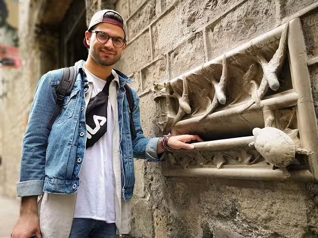Traveler explores historic architecture in Barcelona during a private tour with tapas and drinks, uncovering city secrets.