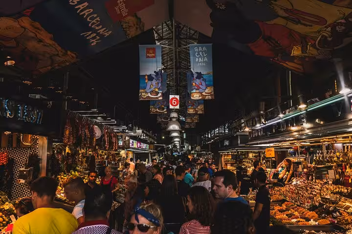 Explore the bustling La Boqueria Market with vibrant stalls on a private full-day tour of Barcelona by car.