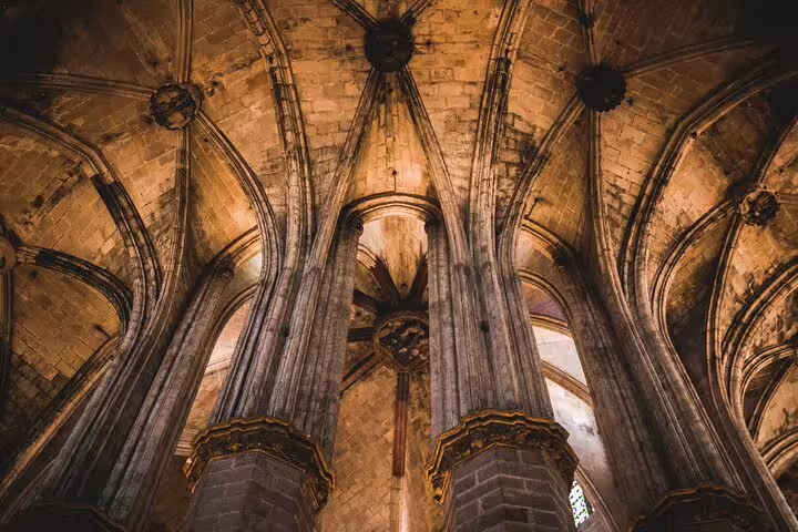 Majestic Gothic cathedral arches and intricate stonework in Barcelona's architectural gems tour.