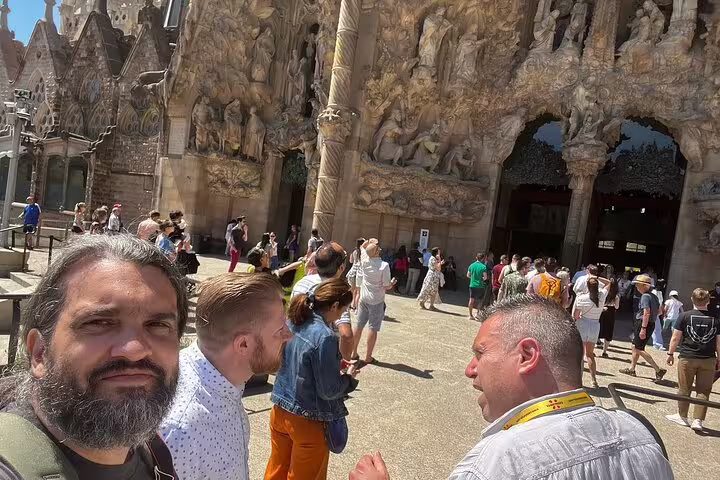 Tour group exploring the intricate façade of Sagrada Familia on a Barcelona VIP Private Tour.