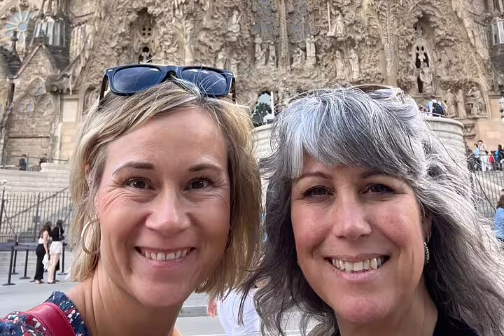 Smiling travelers at Sagrada Familia on a Barcelona scavenger hunt self-guided tour with city sights
