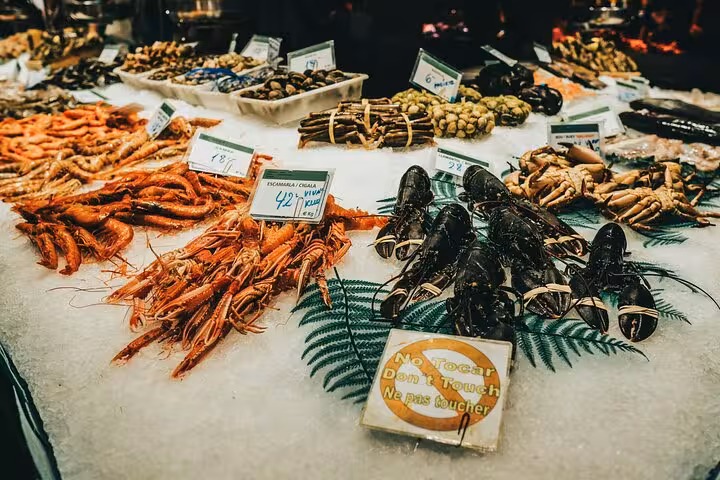 Discover vibrant seafood displays at Barcelona's markets during a private full-day tour by car, rich in culture and flavor.
