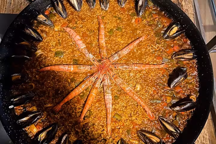 Close-up of a delicious seafood paella with prawns and mussels from a Barcelona cooking class experience.