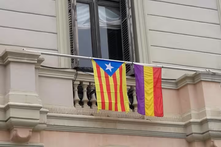 Catalan and Spanish Republic flags on a Barcelona building, highlighting Spanish Civil War history and Franco tour.