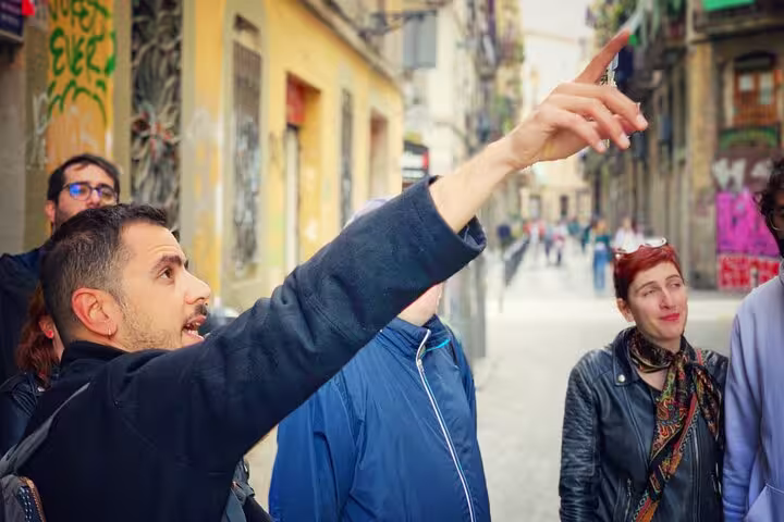 Tour guide leading a group through Barcelona's streets, exploring Spanish Civil War landmarks and history.
