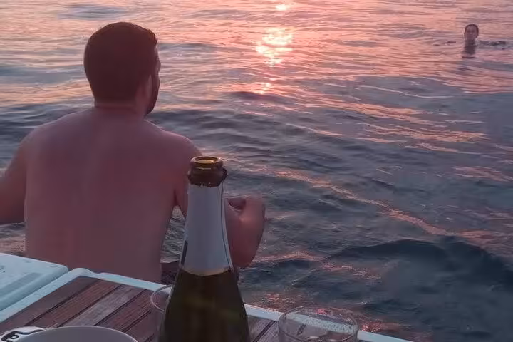 Guest enjoying Barcelona sunset sail with open bar cava and snacks, swimming off a private yacht