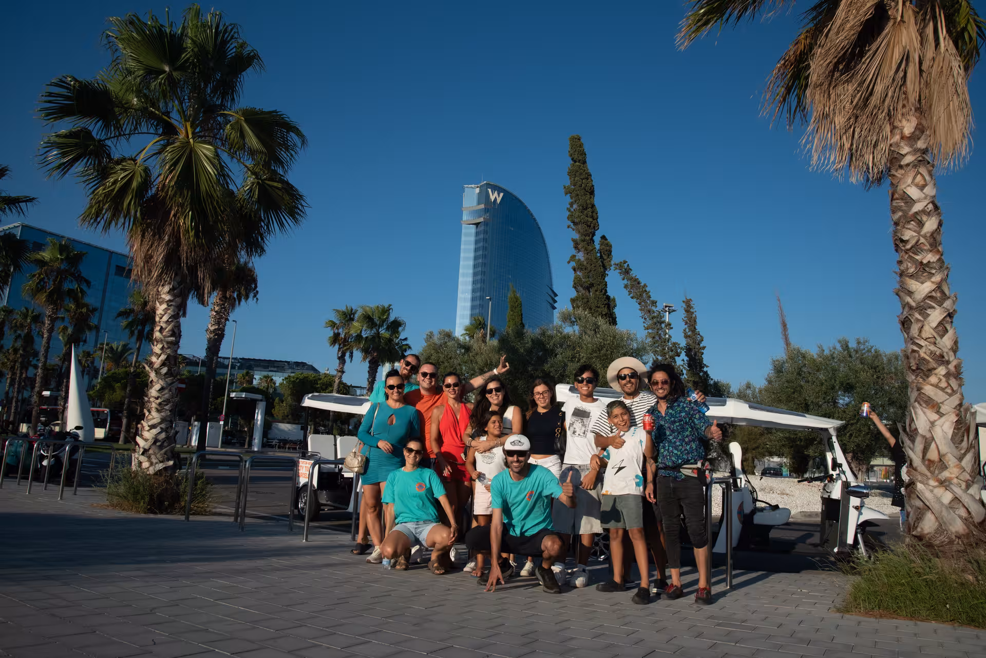 Group photo on Barcelona tuk tuk tour near W Barcelona hotel at Port Vell, a highlight of the Regular city tour