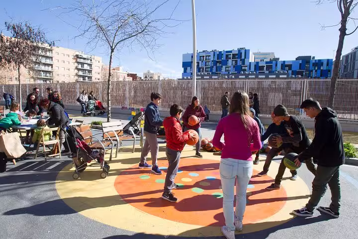 Children play basketball in a vibrant Barcelona urban park, showcasing community engagement in sustainable city design.