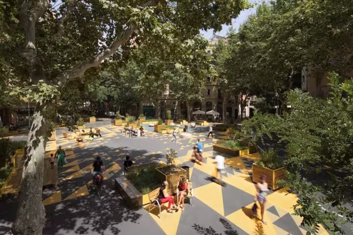 A vibrant, pedestrian-friendly plaza in Barcelona with geometric patterns and greenery, showcasing urban sustainability and community spaces.