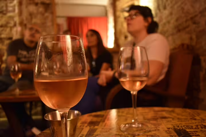 Wine tasting experience in a cozy Barcelona venue during a cultural walking tour.
