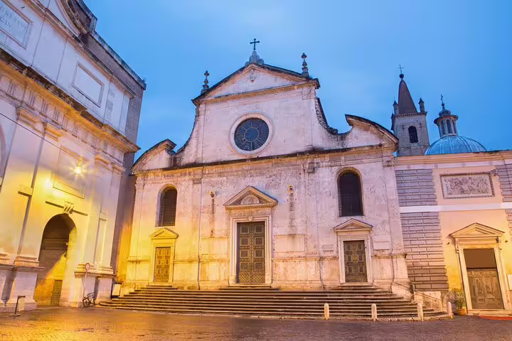 Facade of a historic Baroque church in Rome at dusk, visited on a private Caravaggio and Baroque masterpieces walking tour