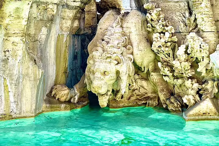 Detail of ornate Baroque fountain sculpture with turquoise water in Rome, included on a Caravaggio and Baroque art private tour