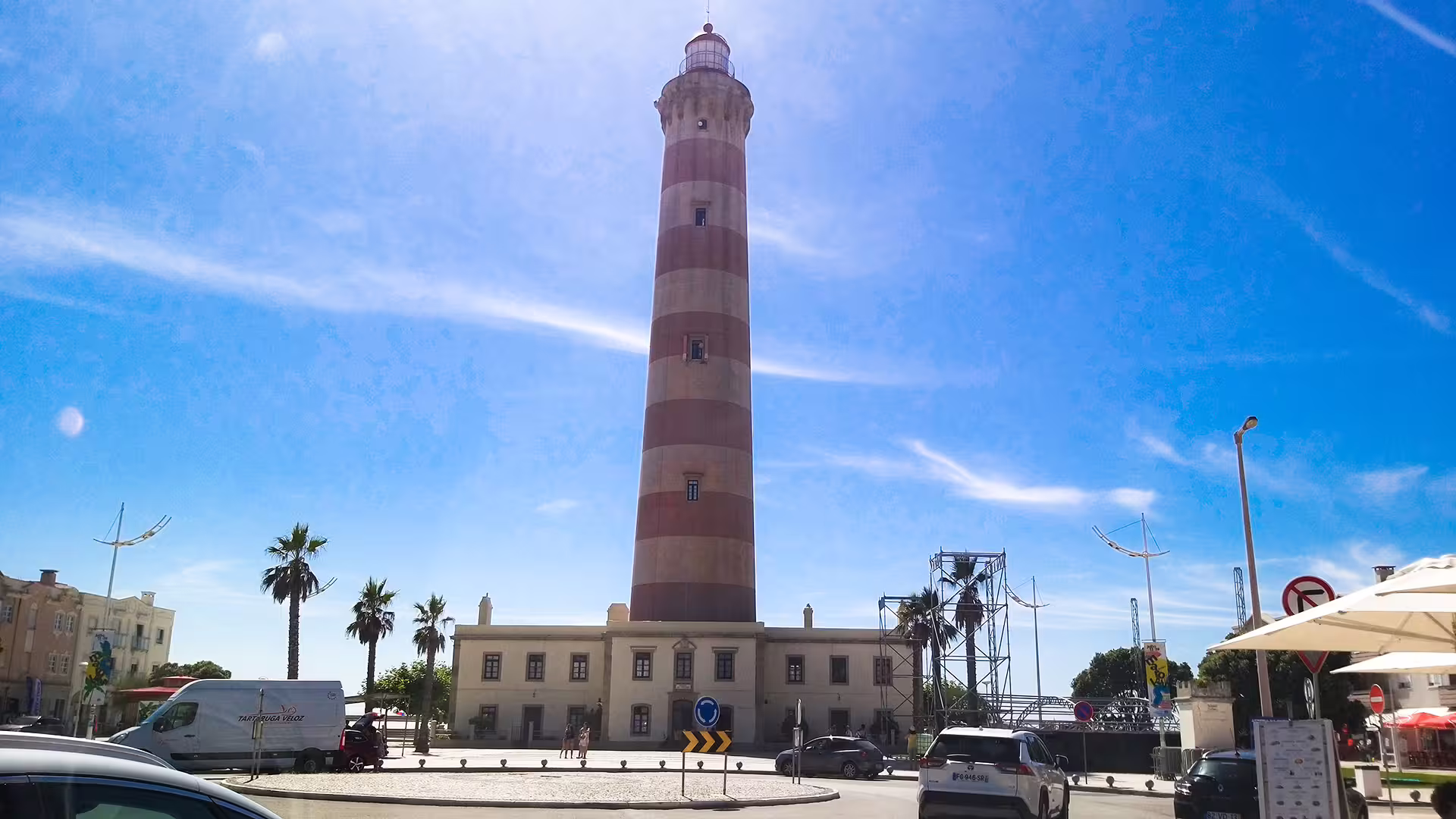 Barra Lighthouse under a clear blue sky, a highlight on the customizable private Porto to Lisbon tour for scenic coastal views.