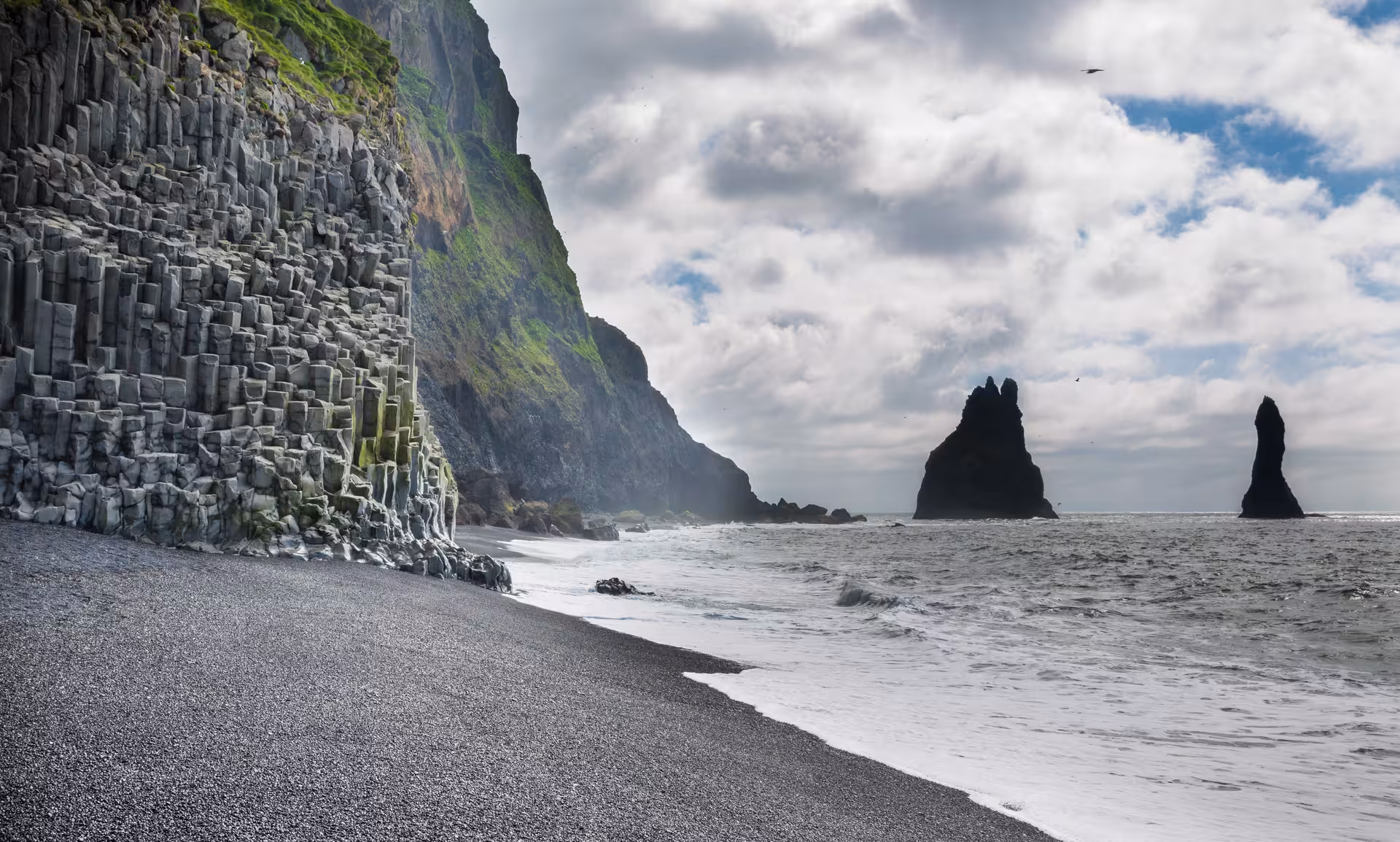 Basalt columns at Reynisfjara with Reynisdrangar sea stacks on South Coast Adventure Rally Car Edition tour