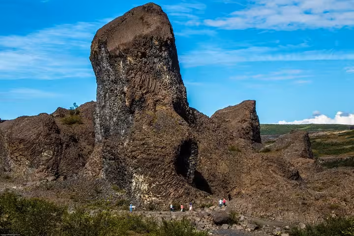 Massive basalt rock formations under a clear blue sky on the Diamond Circle Day Tour from Akureyri.