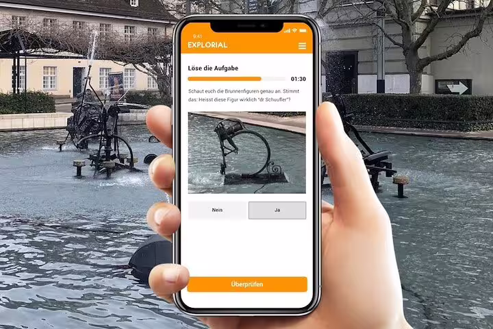 Smartphone app clue at a Basel fountain for a self-guided scavenger hunt and sightseeing walking tour