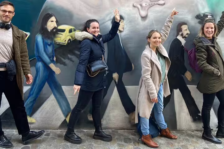Tour guests mimic a mural crosswalk in Basel during a scavenger hunt and sights self-guided walking tour