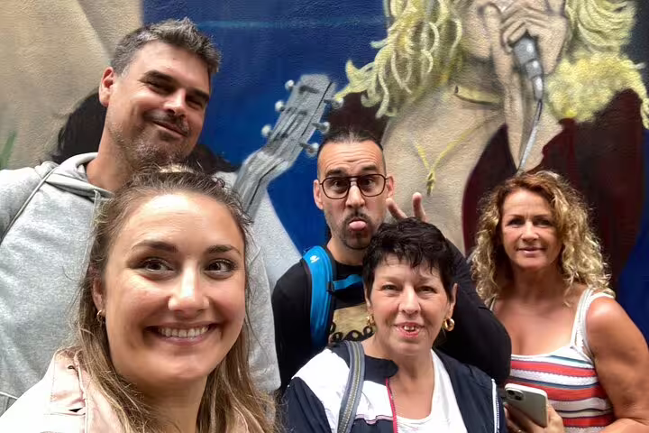 Group selfie at vibrant Basel mural stop during a self-guided scavenger hunt and city sights tour