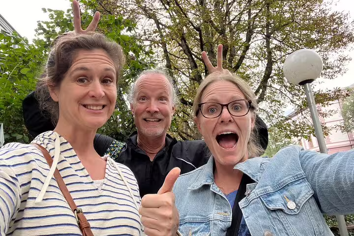 Smiling travelers selfie in Basel park on a self-guided scavenger hunt tour, celebrating city sights