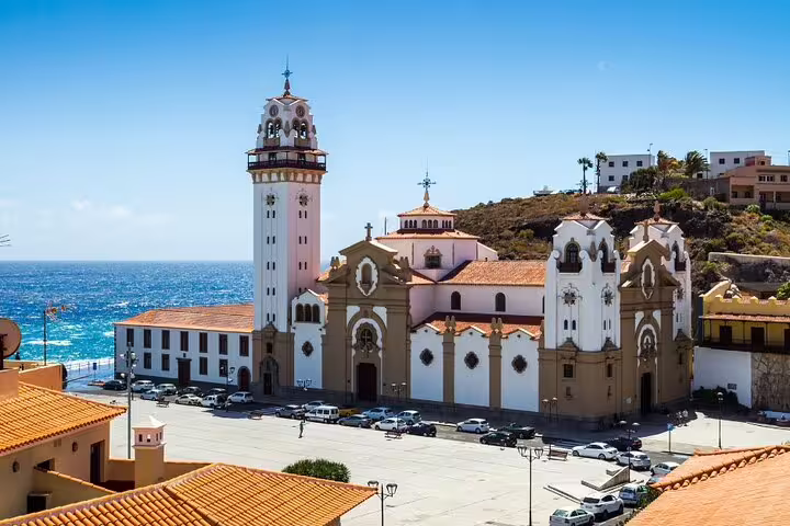 Scenic view of the Basilica of Candelaria against the ocean backdrop on a sunny day in Tenerife.